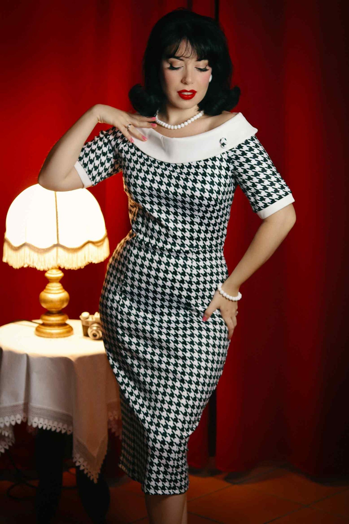 A model wearing a Houndstooth Fitted Off Shoulder Dress