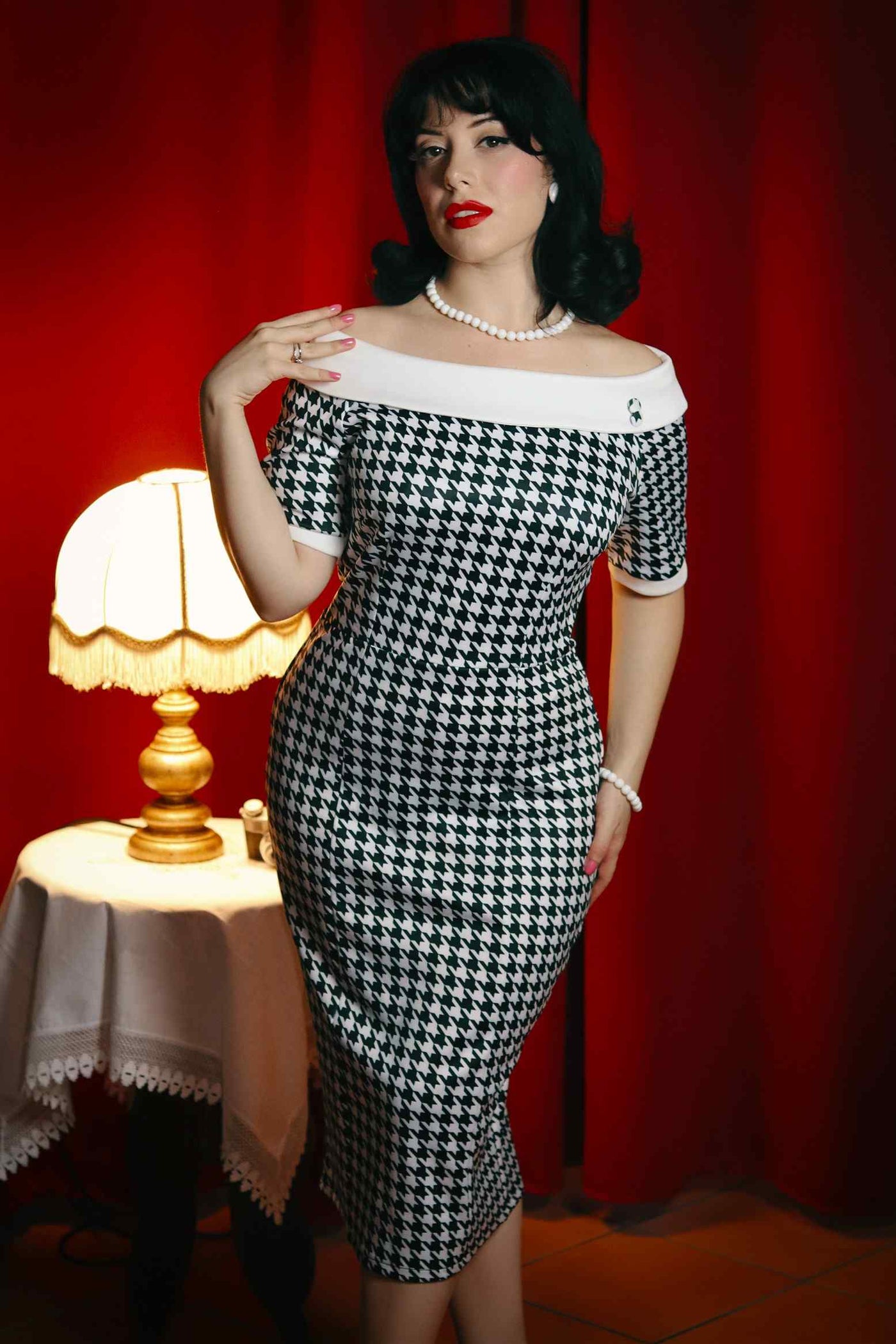 A model wearing a Houndstooth Fitted Off Shoulder Dress