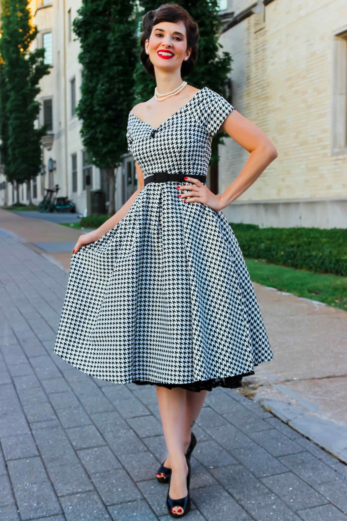 A model wearing a Houndstooth Sleeved Full Circle Dress in Black/White