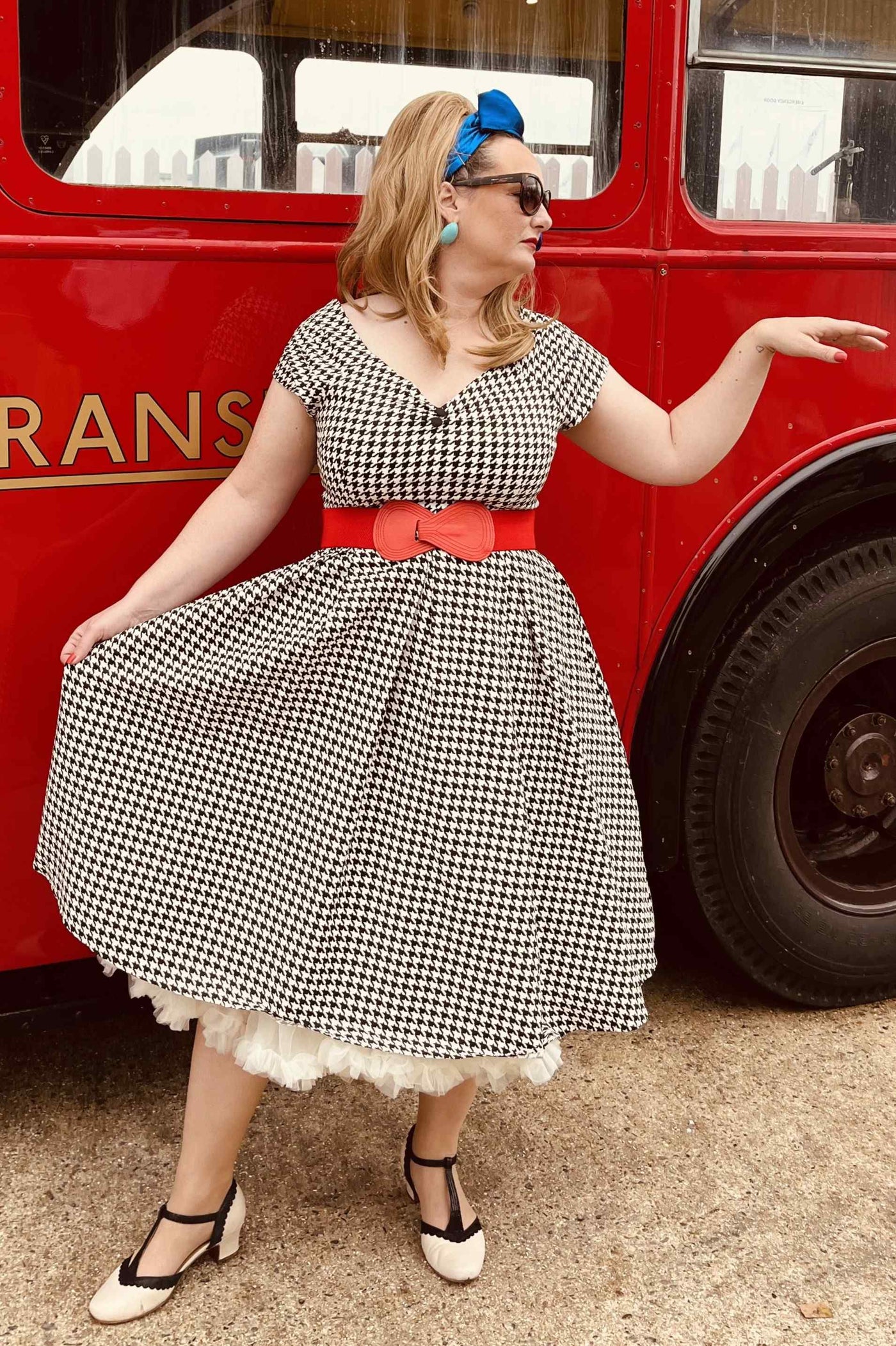 A lady wearing a Houndstooth Sleeved Full Circle Dress in Black/White