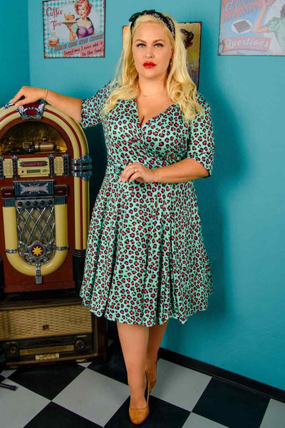 A lady wearing  a Leopard Print Wrap Dress In Green