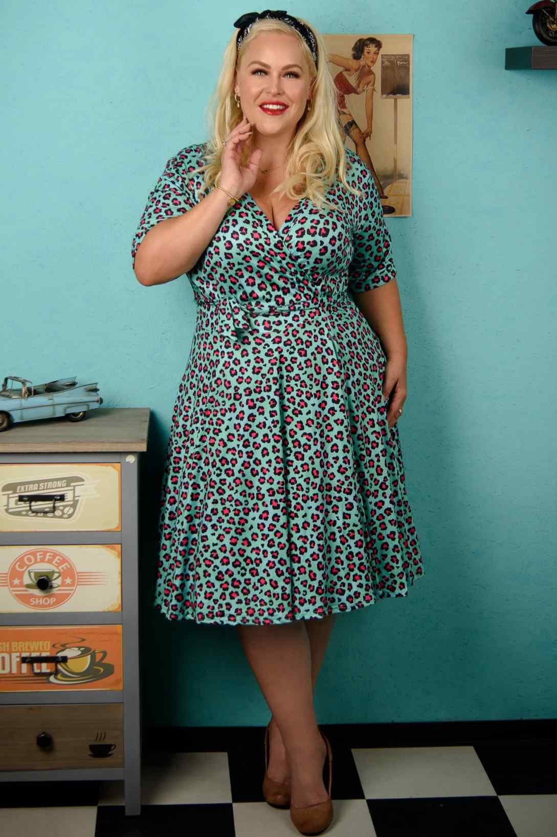 A lady wearing  a Leopard Print Wrap Dress In Green