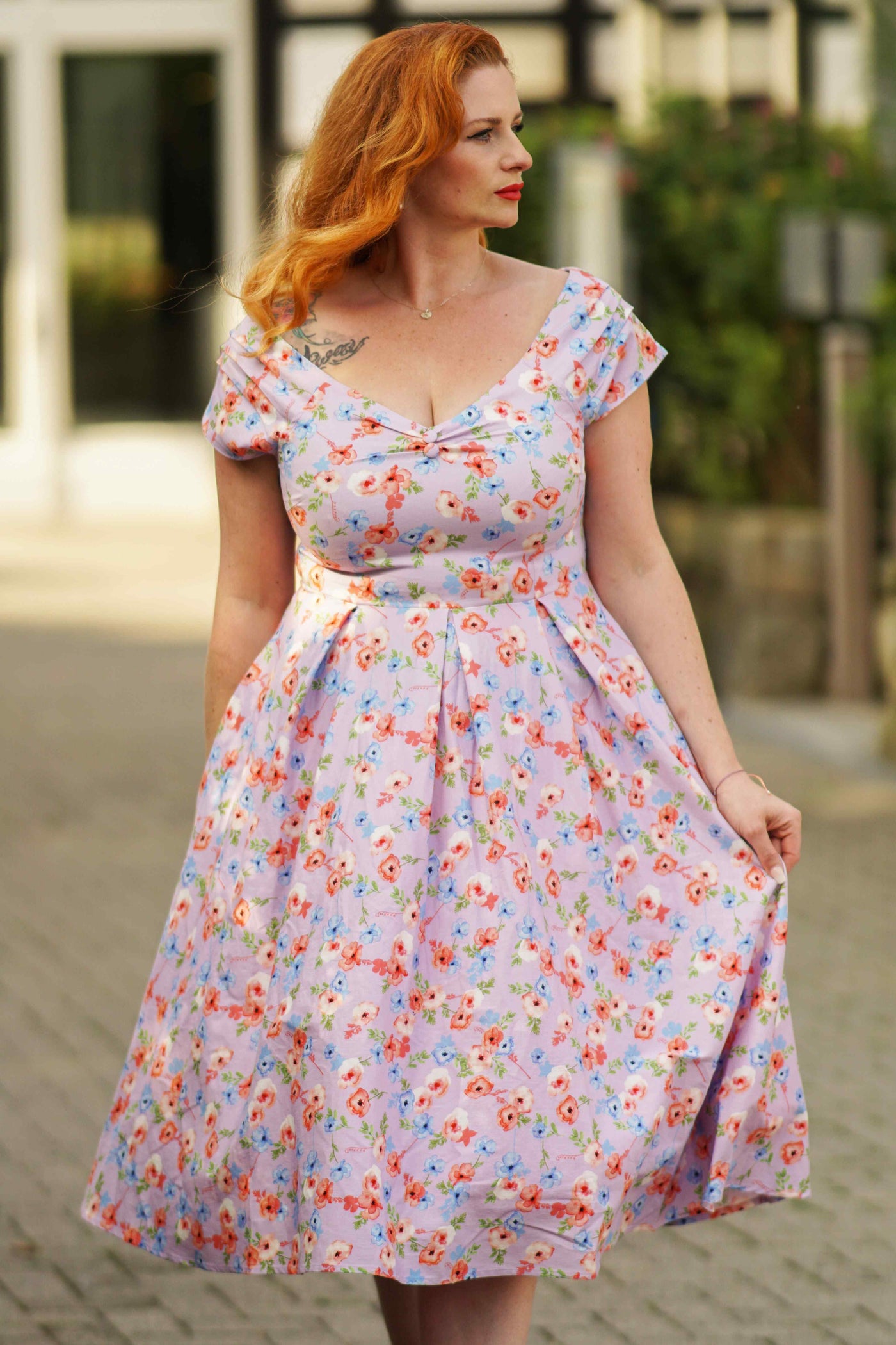 A model wearing a  Lilac Watercolour Floral Off Shoulder Dress