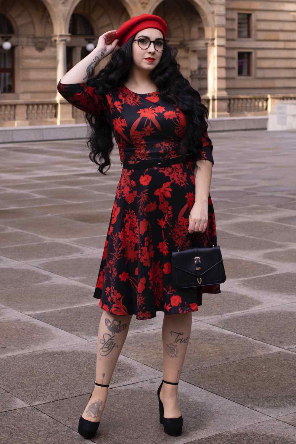 A lady wearing a Long Sleeved Midi Dress in Black/Red Floral