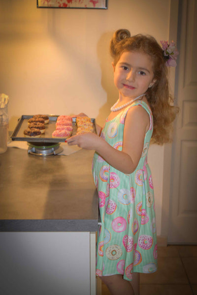 A cute child wearing Mint Donut Tea Dress