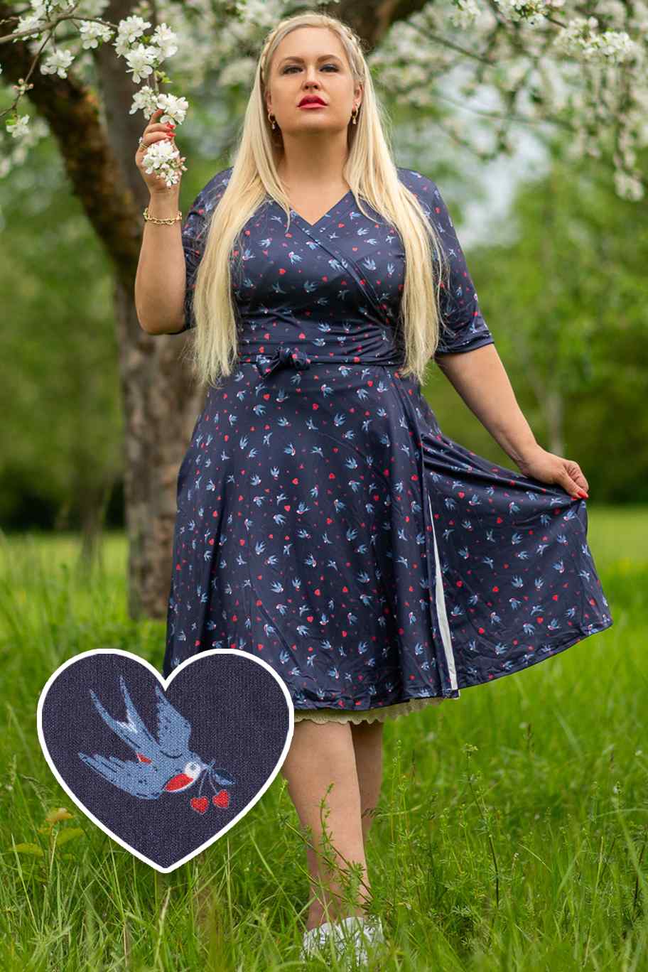 A model wearing a Navy Blue Heart & Swallow Wrap Dress