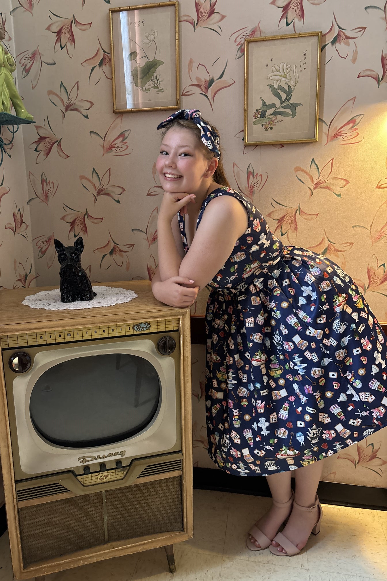 A model wearing Navy Blue Wonderland Swing Dress and headband