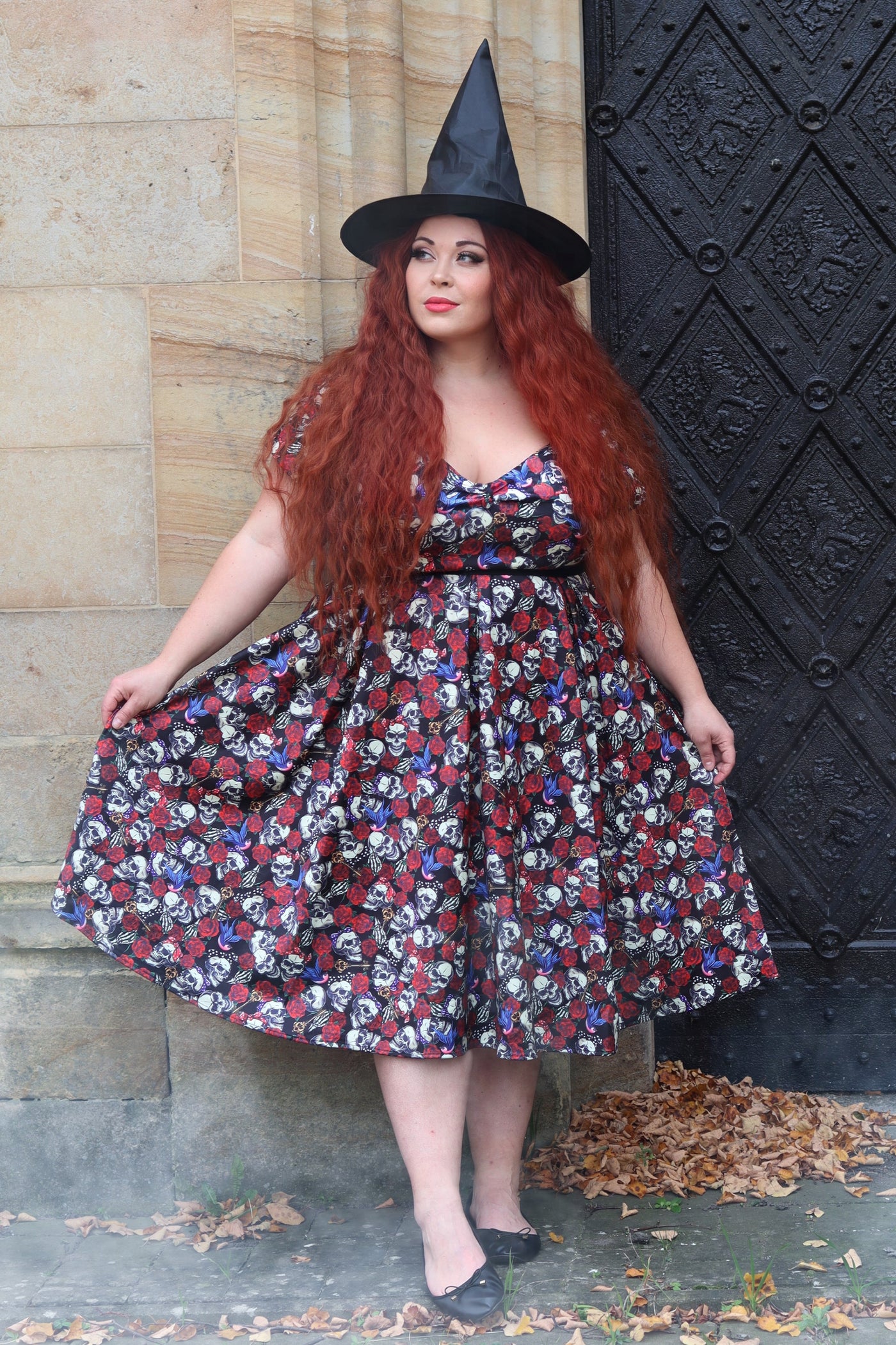 A lady wearing an  Off Shoulder 50s Rockabilly Skull Dress