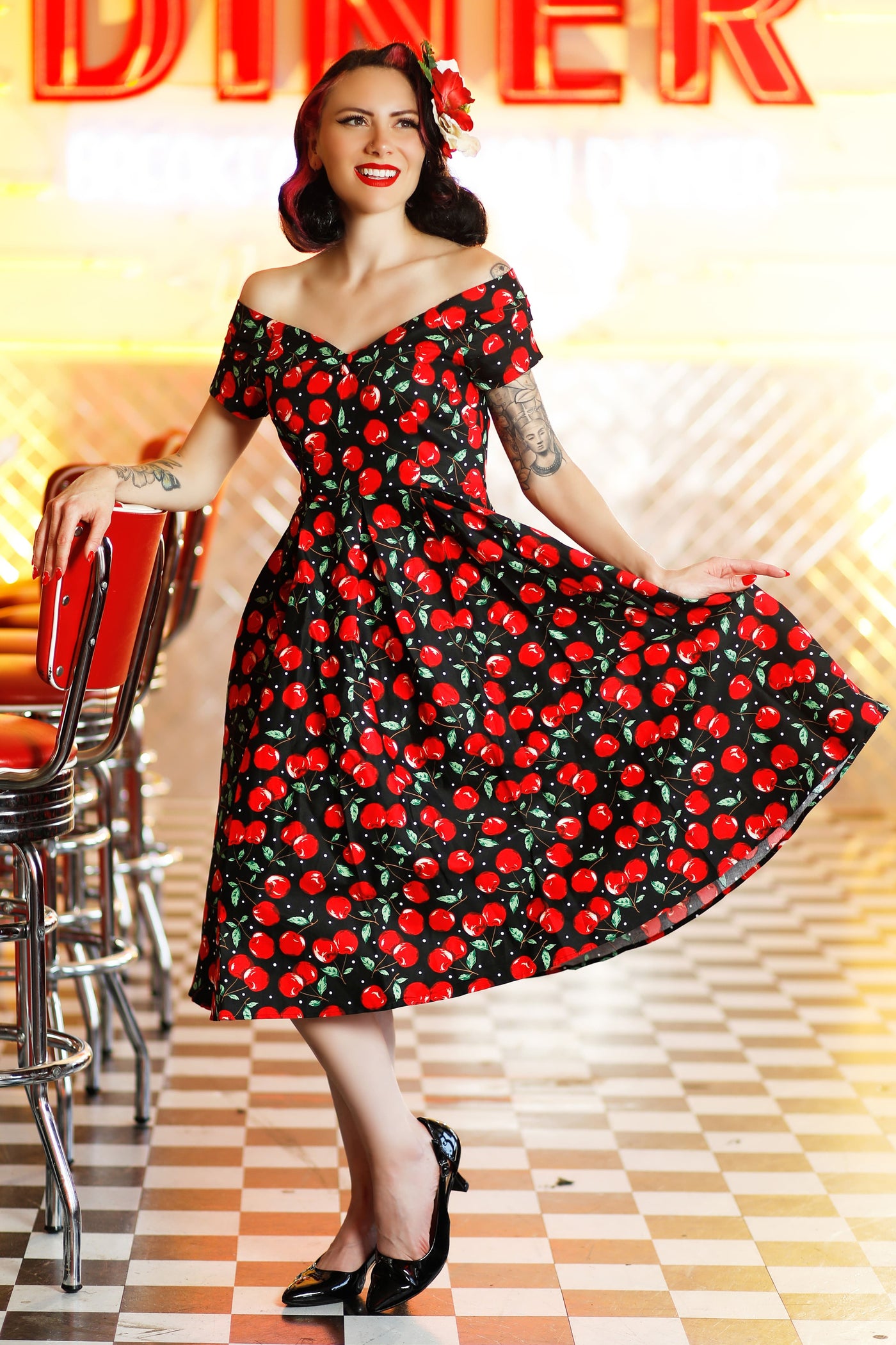 A model wearing a Off Shoulder Cherry Swing Dress