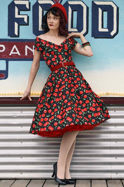 A model wearing a Off Shoulder Cherry Swing Dress