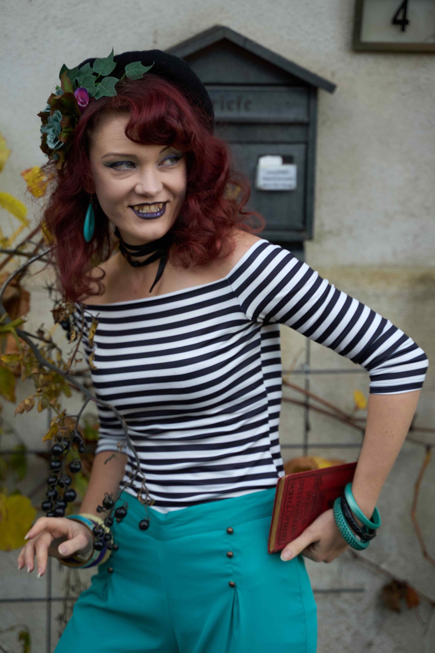 A lady wearing an Off Shoulder Retro Striped Top in Black