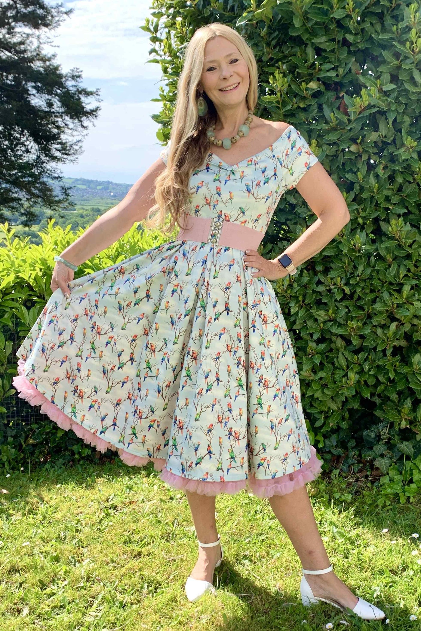 A lady wearing a Light Green Parrot Off Shoulder Dress