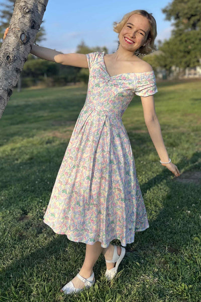 A model wearing a Pastel Dinosaur Off Shoulder Dress