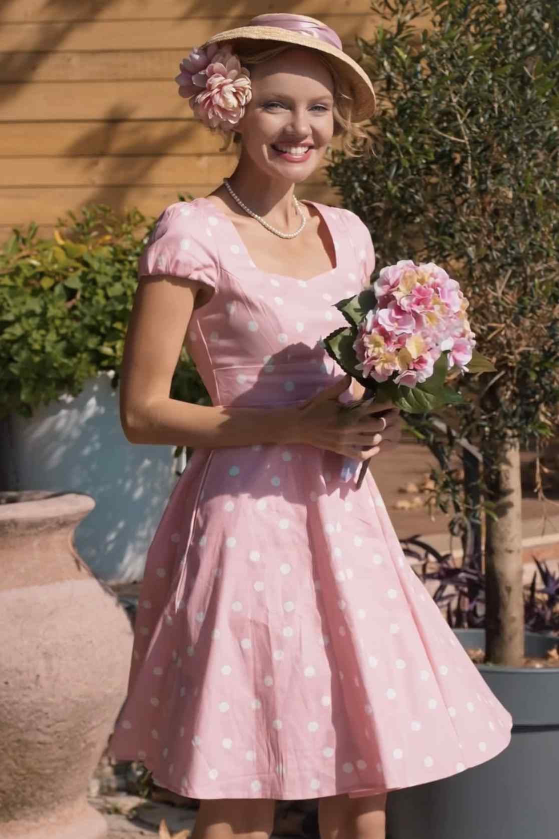 A model wearing Pink Polka Dot Skater Dress