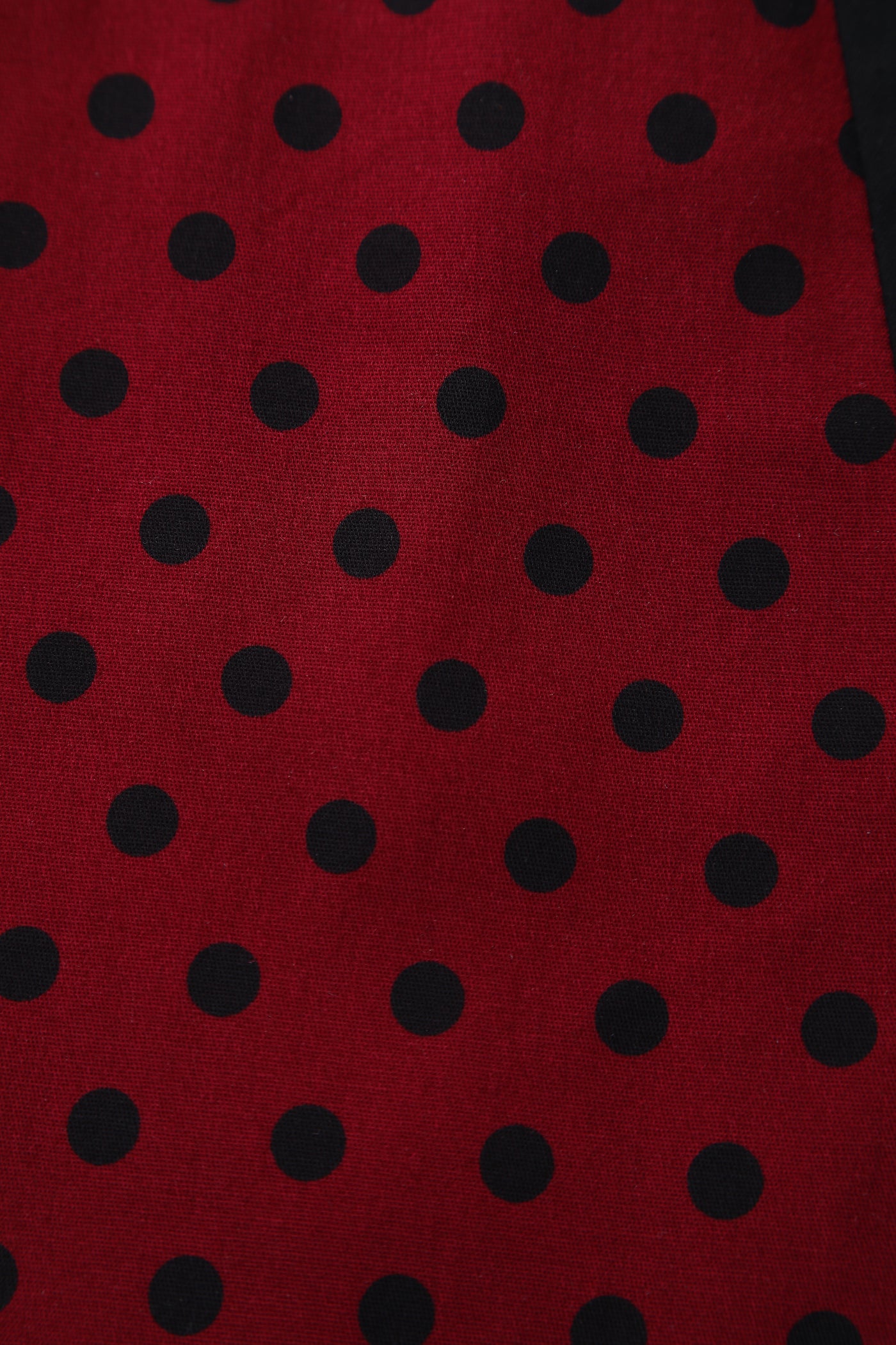 Close up view of Pleated Black Dress With Burgundy Polka Dots