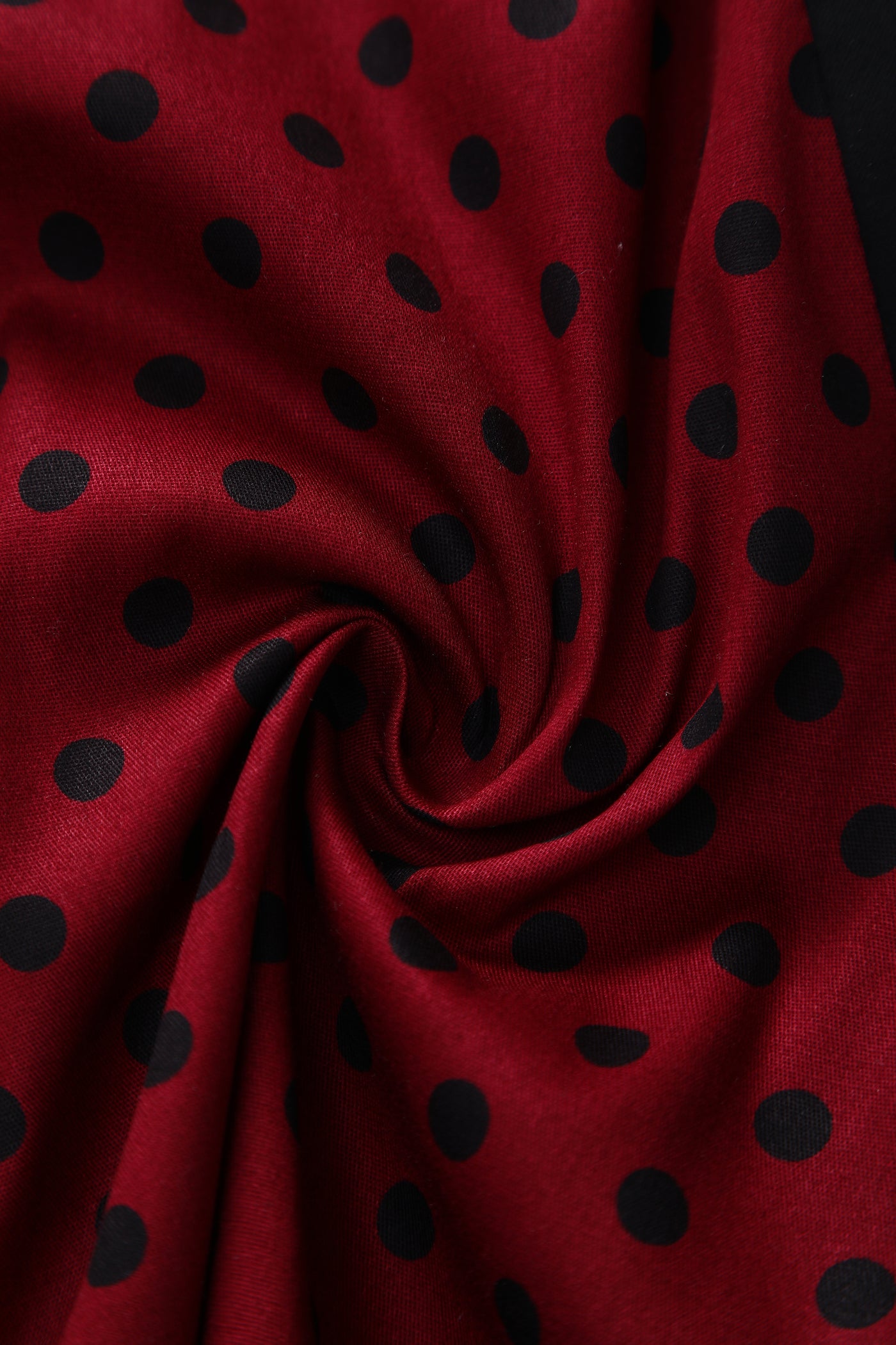 Close up view of Pleated Black Dress With Burgundy Polka Dots