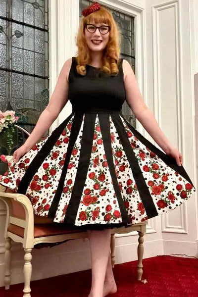 A lady wearing a Pleated Black Dress With Retro Roses & Spots