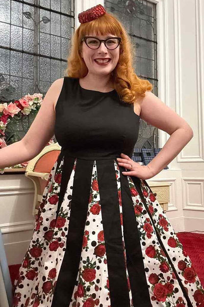 A lady wearing a Pleated Black Dress With Retro Roses & Spots