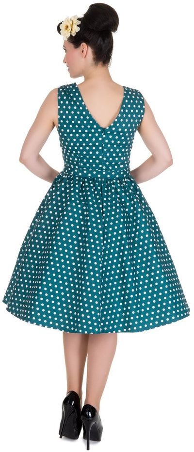 Model wears our V neck swing dress, in teal polka dot print, back view