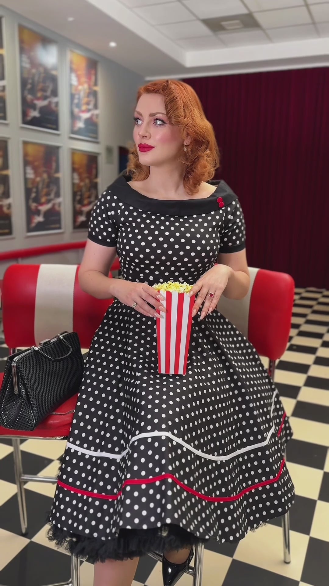 A model wearing a Retro Swing Dress in Black-White Polka Dots