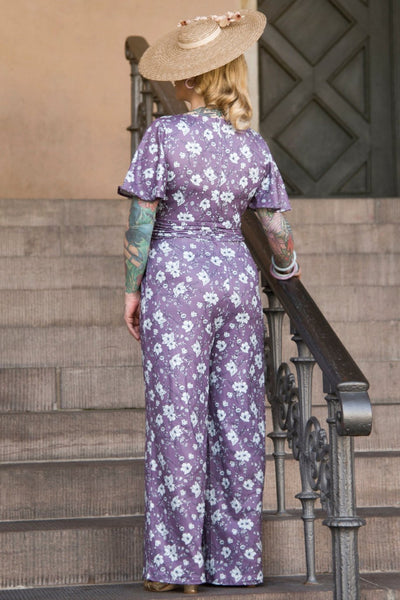 A model wearing a Purple Floral Butterfly Sleeved Jumpsuit