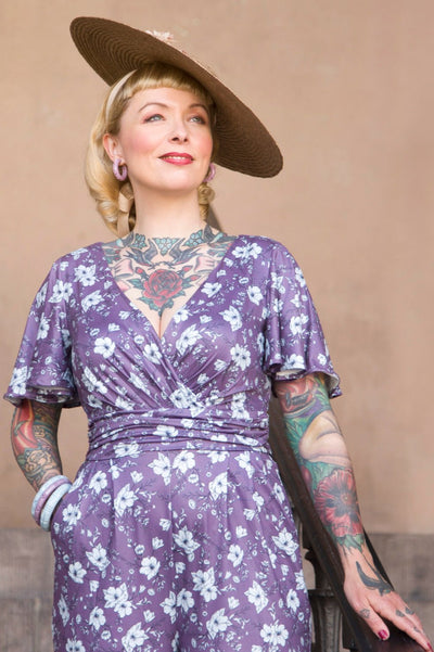 A model wearing a Purple Floral Butterfly Sleeved Jumpsuit