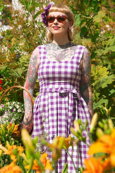 A lady wearing a Purple Gingham Swing Dress