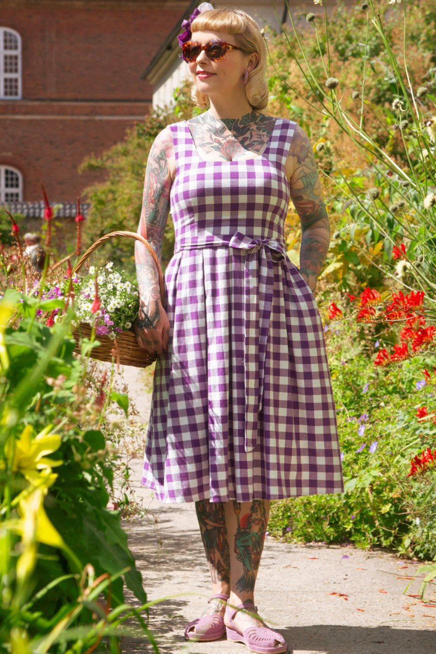 A lady wearing a Purple Gingham Swing Dress