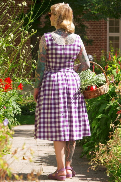 A lady wearing a Purple Gingham Swing Dress