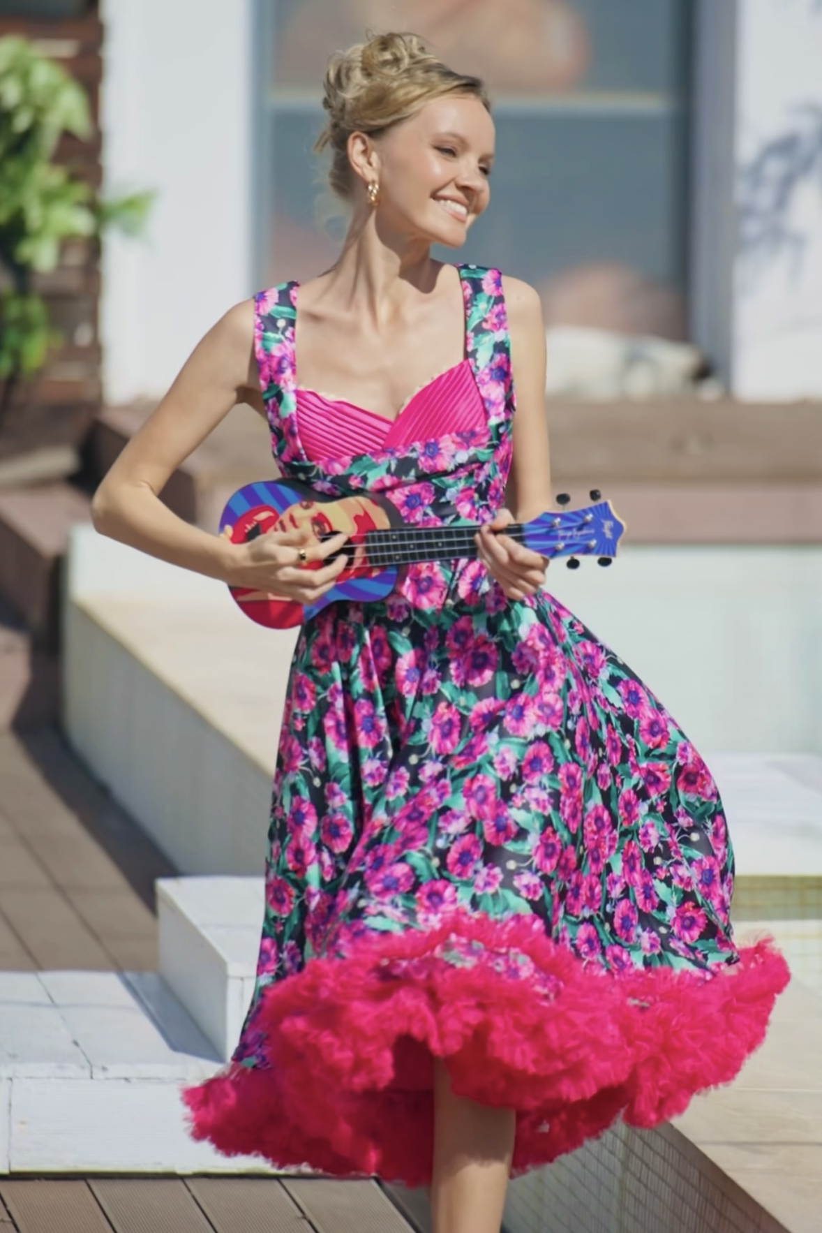 A lady wearing a Purple Poppy Pleated Bust Dress