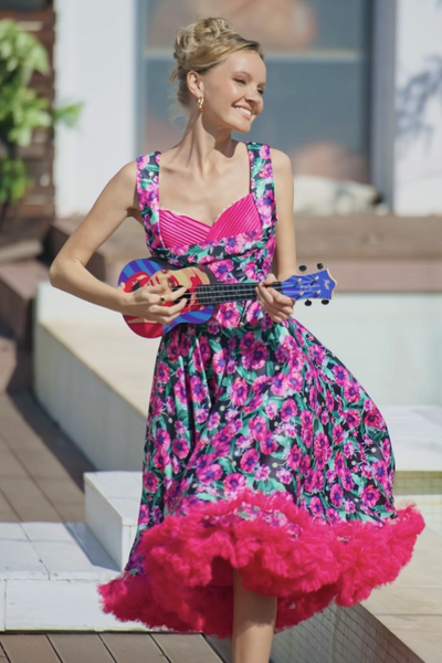 A lady wearing a Purple Poppy Pleated Bust Dress