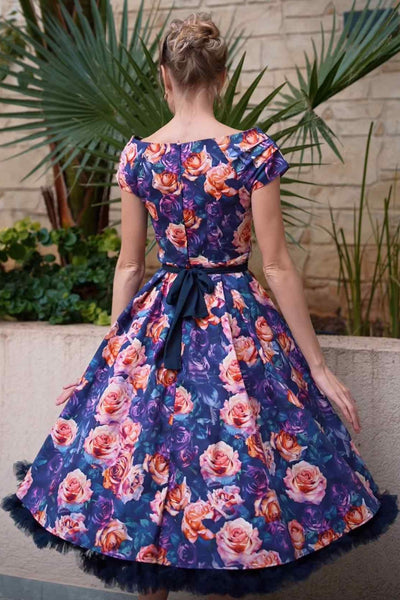 A lady wearing a Purple Rose Garden Off Shoulder Dress