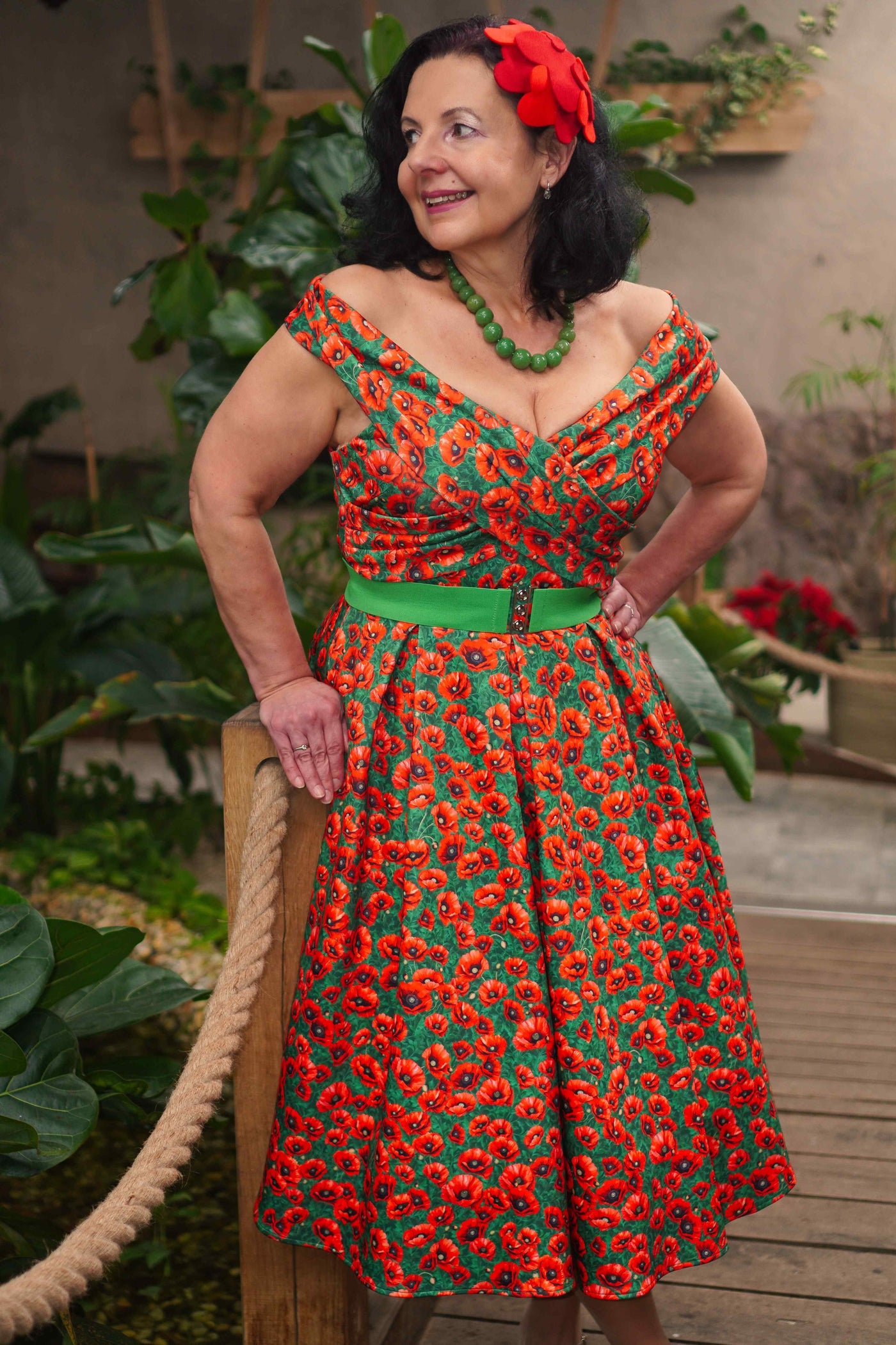 A lady wearing a Red Poppy Garden Off Shoulder Dress