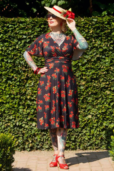 A model wearing Red Rose Crossover Bust Dress