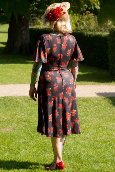 A model wearing Red Rose Crossover Bust Dress