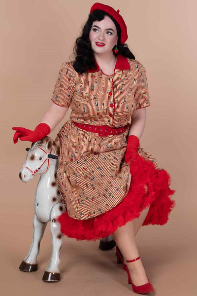 A model wearing a  Red Vintage Circus Striped Shirt Dress