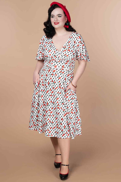 A model wearing a Retro Cherry Polka Dot Dress