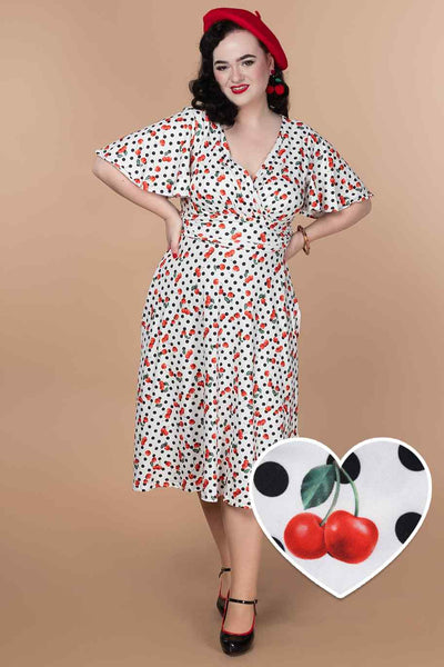 A model wearing a Retro Cherry Polka Dot Dress