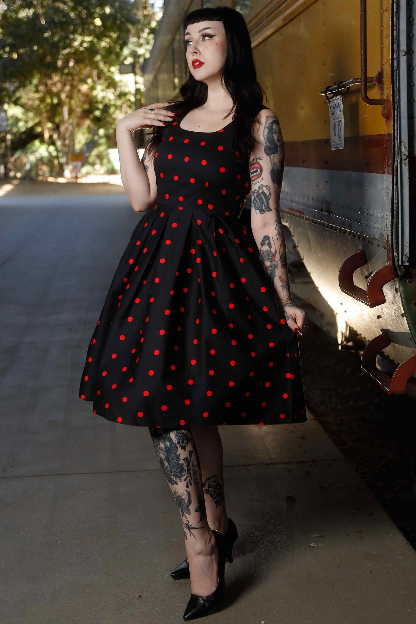 Front view of model wearing Retro Polka Dot Swing Dress in Black & Red