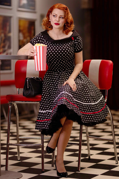 A model wearing a Retro Swing Dress in Black-White Polka Dots