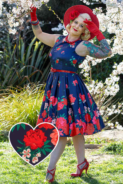 A model wearing Retro Swing Dress in Purple with Raising Rose Print