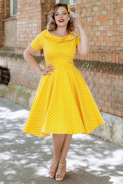 A model wearing a Retro Yellow Polka Dot Swing Dress