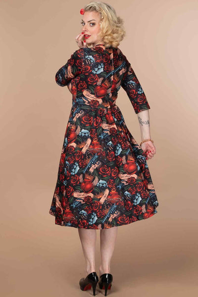 A model wearing a Rockabilly Guns n Roses Dress