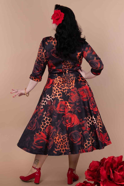 A model wearing a ockabilly Leopard Rose Midi Dress