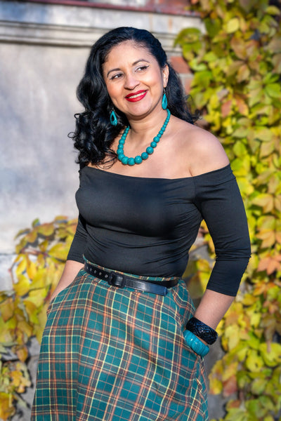 A model wearing a Green Tartan Skater Skirt and Rockabilly Off Shoulder Black Top