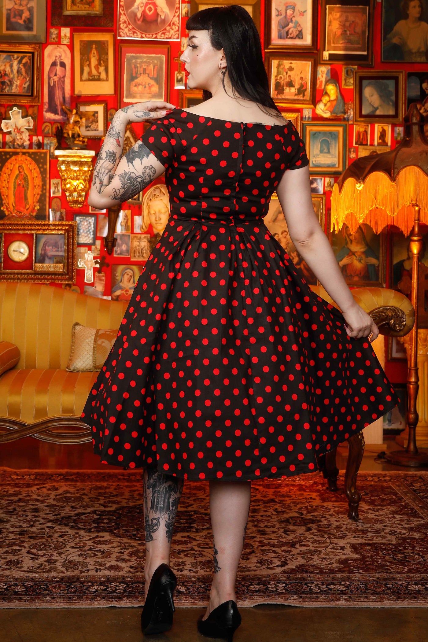 A model wearing a Rockabilly Polka Dot Off Shoulder Swing Dress In Black & Red