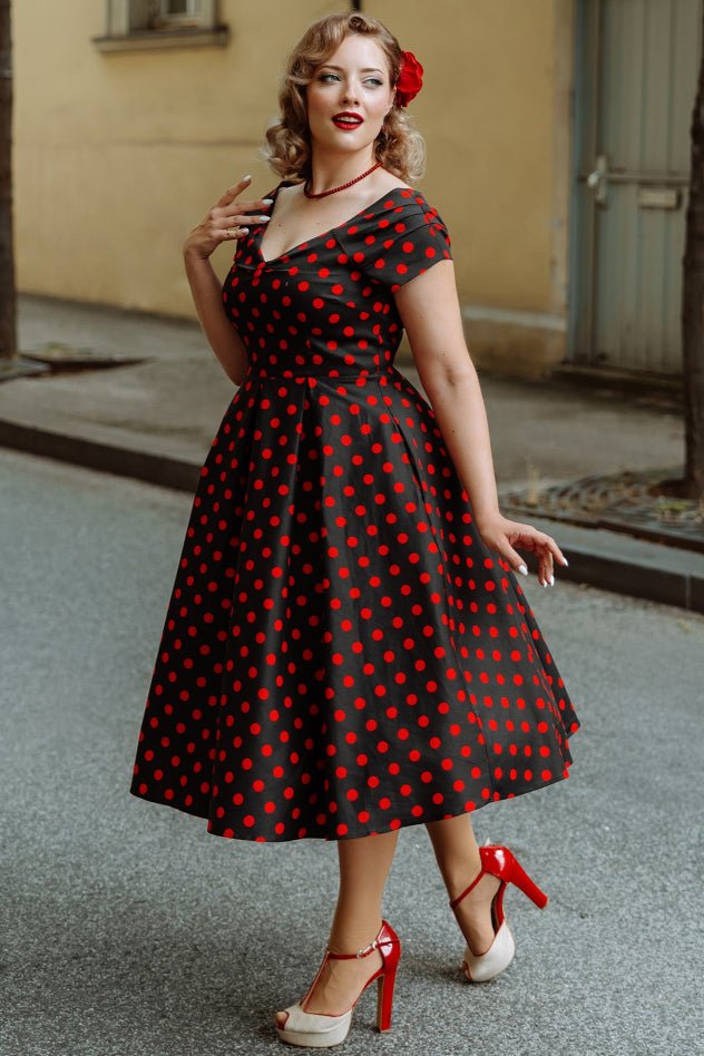 A model wearing a Rockabilly Polka Dot Off Shoulder Swing Dress In Black & Red