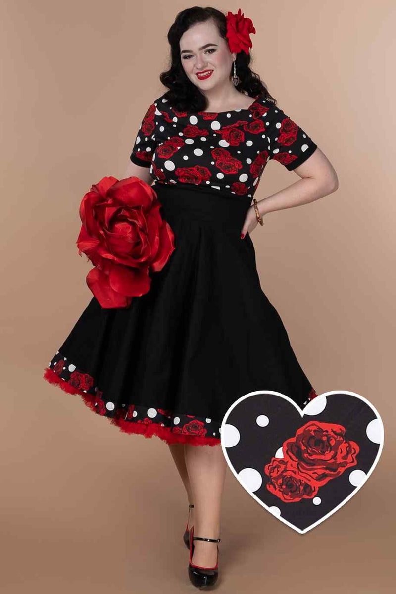 A model wearing Rockabilly Rose Polka Dot Swing Dress