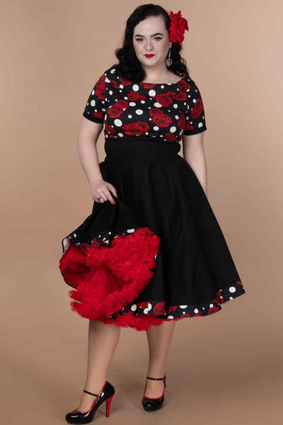 A model wearing Rockabilly Rose Polka Dot Swing Dress