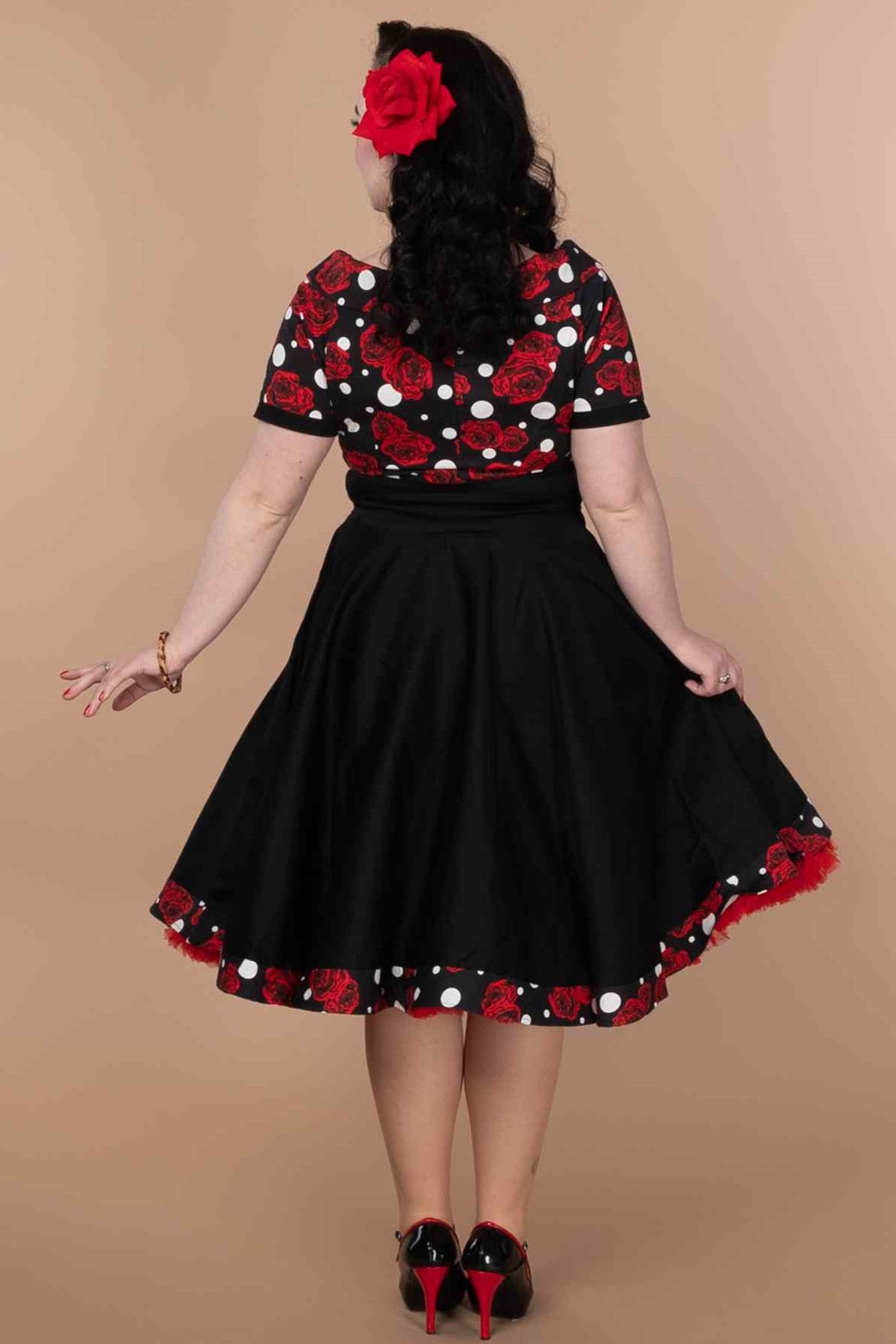 A model wearing Rockabilly Rose Polka Dot Swing Dress